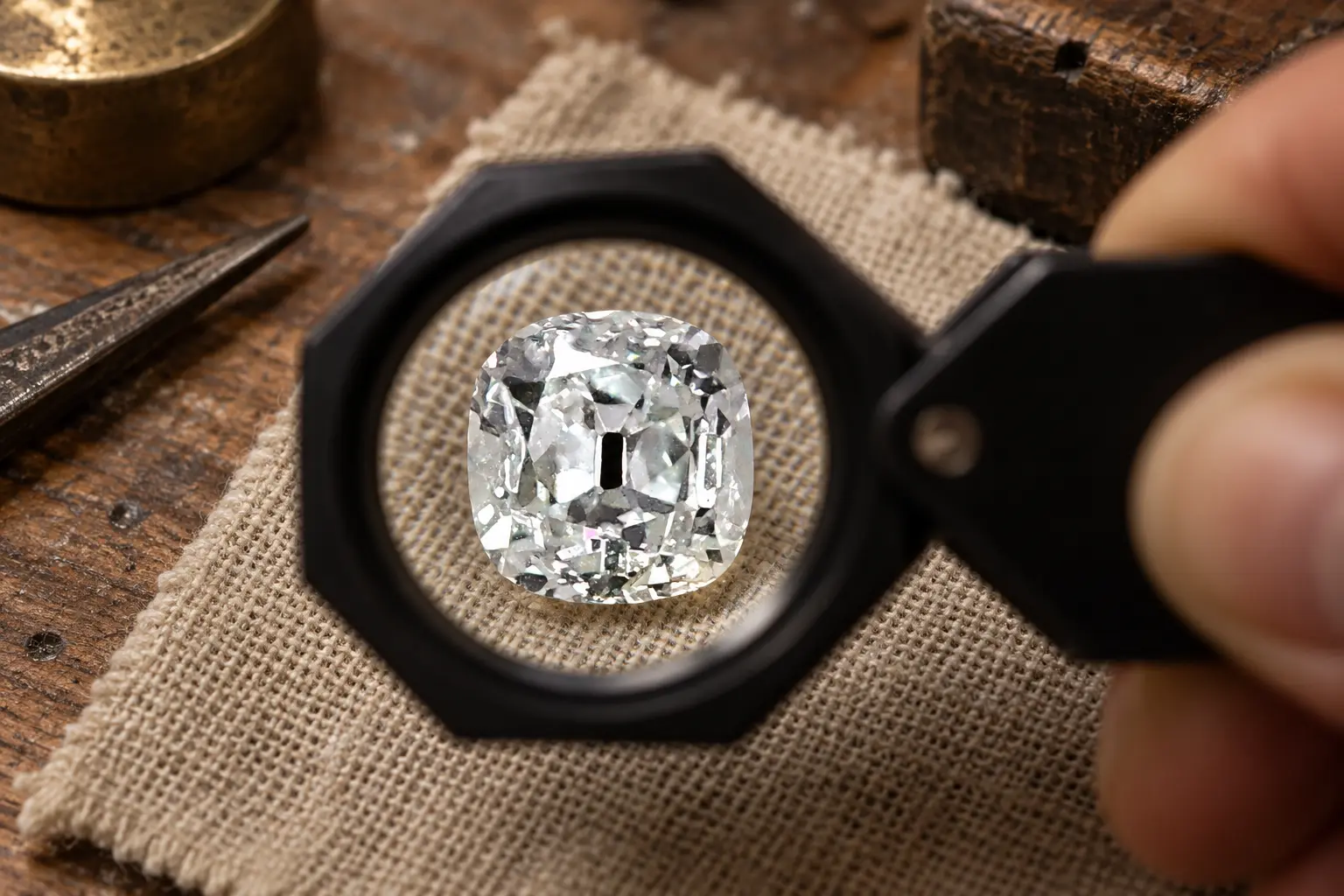 Generated editorial view of an old mine cushion through a folding loupe.