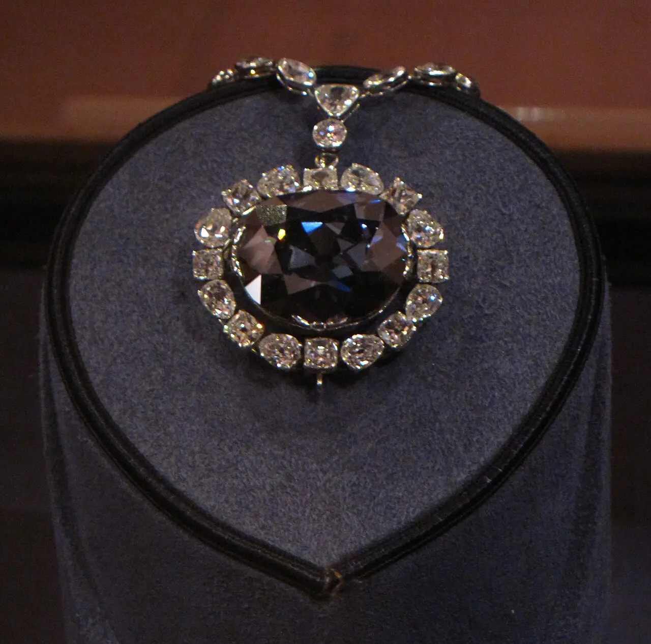 The Hope Diamond surrounded by white diamonds in its necklace.
