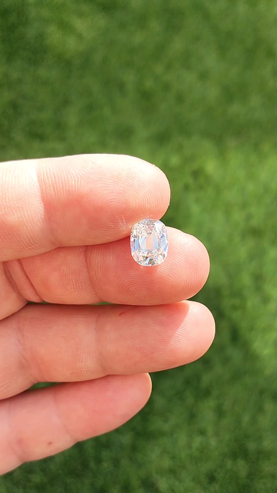 3.09 Ct. F SI2 Old Mine Cushion shown loose on a hand